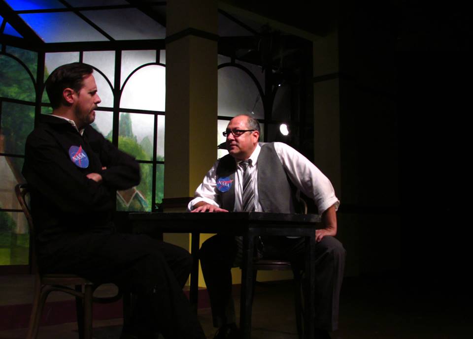Mike (Eric Curtis Johnson) is assured by Gene (Bruno Oliver) that the new moon mission will make him a hero.