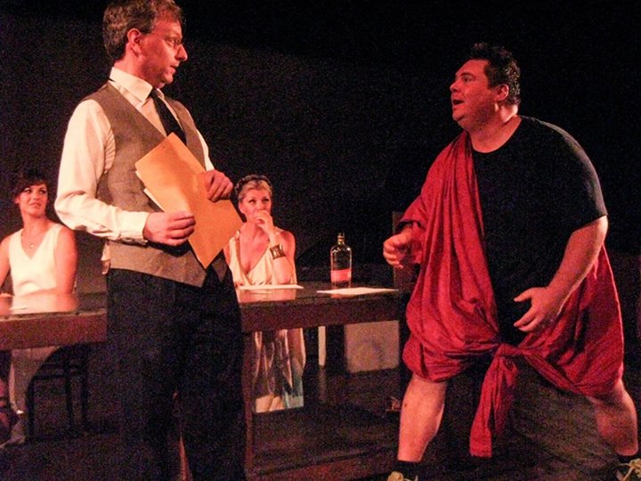 Dionysus (Scott Legget, R) is incensed when Mr. Corgi (Corey Klemow, L) suggests they spend less time turning humans into animals to have sex with. What's the point of being a god, then!?