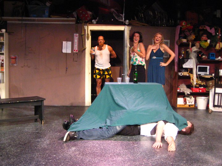Mr. Rivers (Bruno Oliver) has been stabbed, but manages to pour himself several drinks before dying.