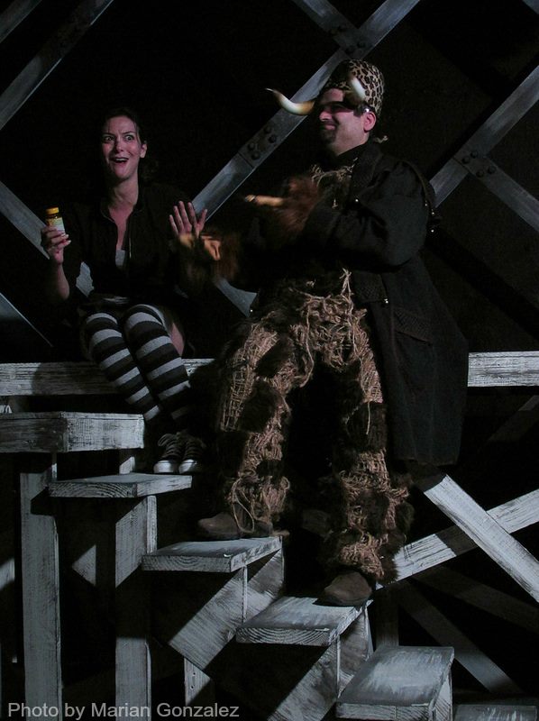 The Monster (Mike Mahaffey) encourages Cookie (Jaime Andrews) to gorge on multivitamins.