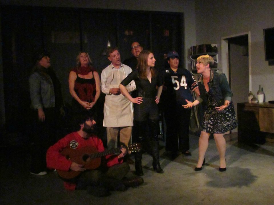 Taylor Swift leads her hordes in a song about H.Y.D.R.O.X.'s true motivations. (L-R: Jamie Fluet, Cj Merriman, Zachary Bernstein [sitting], Corey Klemow, Bruno Oliver, Julia Griswold, Jenelle Riley & Shannon Nelson)