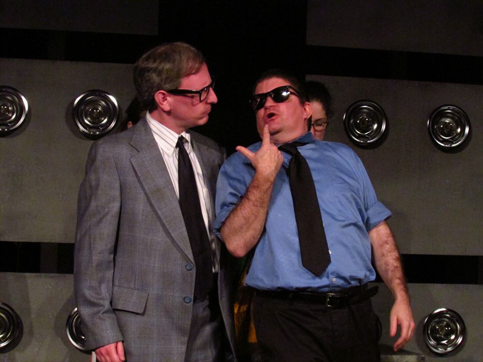 Pops (Corey Klemow) stops Louie (Jay Bogdanowitsch) from spiking the punch.